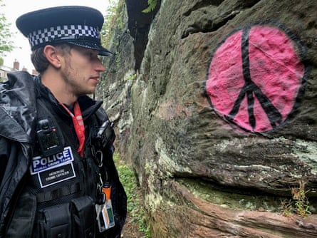 Heritage crime officer, PC Ashley Tether, looks at the graffiti on the city walls of Chester.