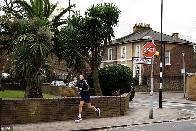 A man jogs by the new artwork in Peckham today