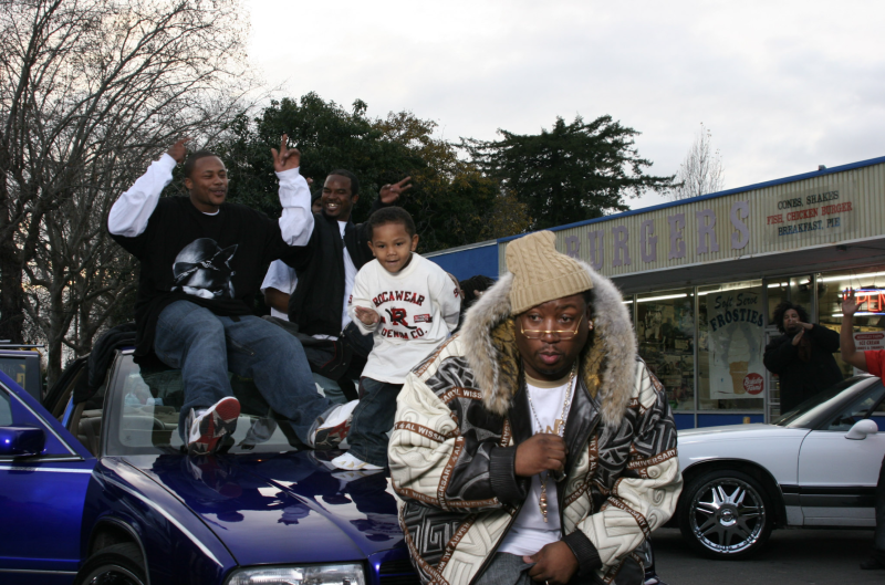 The ambassador of the Bay, E-40, sitting on his scraper watching Oakland going wild while on the set of the video for the hit song 