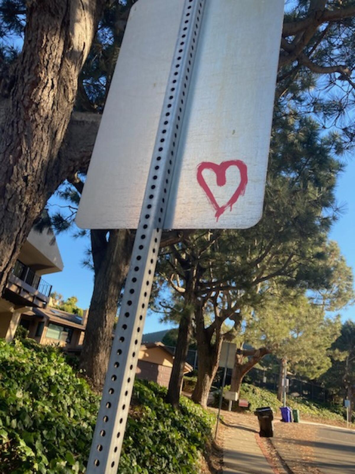 Many of the graffiti hearts have been painted on street signs.