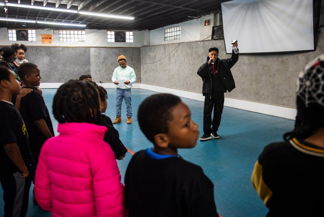 DJ Butter, right, and Toby Tansil, youth coordinator at the Alkebu-lan Village, left, welcome participants during Dilla Family Day at the Alkebu-lan Village on Saturday, Feb. 10, 2024 in Detroit. The event featured roller skating, educational workshops and a pizza lunch.