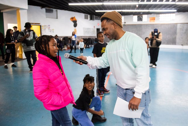 Toby Tansil, youth coordinator at the Alkebu-lan Village, right, asks participants what they're enjoying about the event during Dilla Family Day at the Alkebu-lan Village on Saturday, Feb. 10, 2024 in Detroit. The event featured roller skating, educational workshops and a pizza lunch.