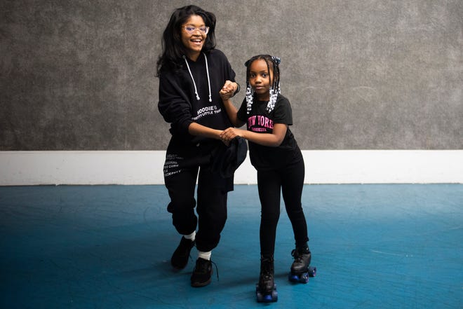 Kimora Riddick, left, helps Kendall Palmer, 8, right, while she roller skates during Dilla Family Day at the Alkebu-lan Village on Saturday, Feb. 10, 2024 in Detroit. The event featured roller skating, educational workshops and a pizza lunch.