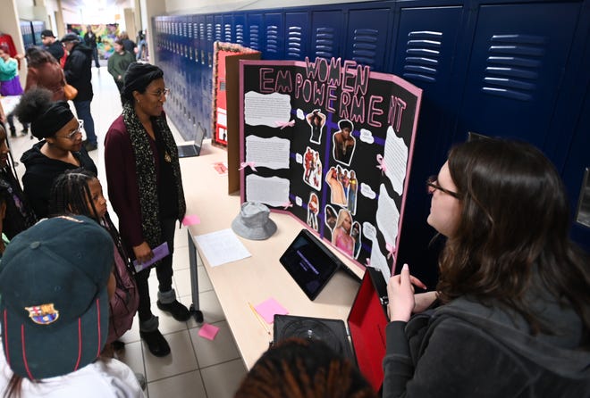 Lansing Eastern students and parents check out one of the hip-hop museum stations created by Honors English freshman and sophomore students as part of their project-based learning class 'Finding Common Ground: This is Hip-Hop 50th Anniversary