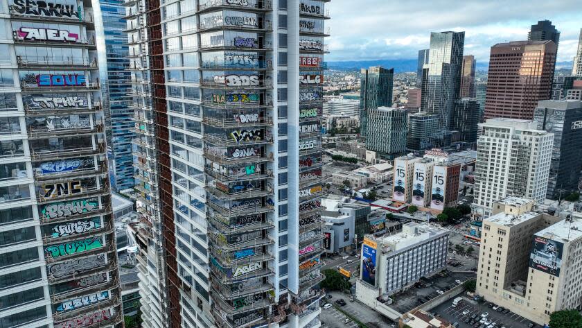 Los Angeles, CA, Thursday, February 1, 2024 - Taggers have graffitied what appears to be more than 25 stories of a downtown Los Angeles skyscraper that's been sitting dormant for several years. Construction on Oceanwide Plaza, a $1 billion mixed-use retail and luxury apartments project with three towering unfinished structures, stalled in January 2019 after the Beijing-based developer lacked the funds to complete it. (Robert Gauthier/Los Angeles Times)