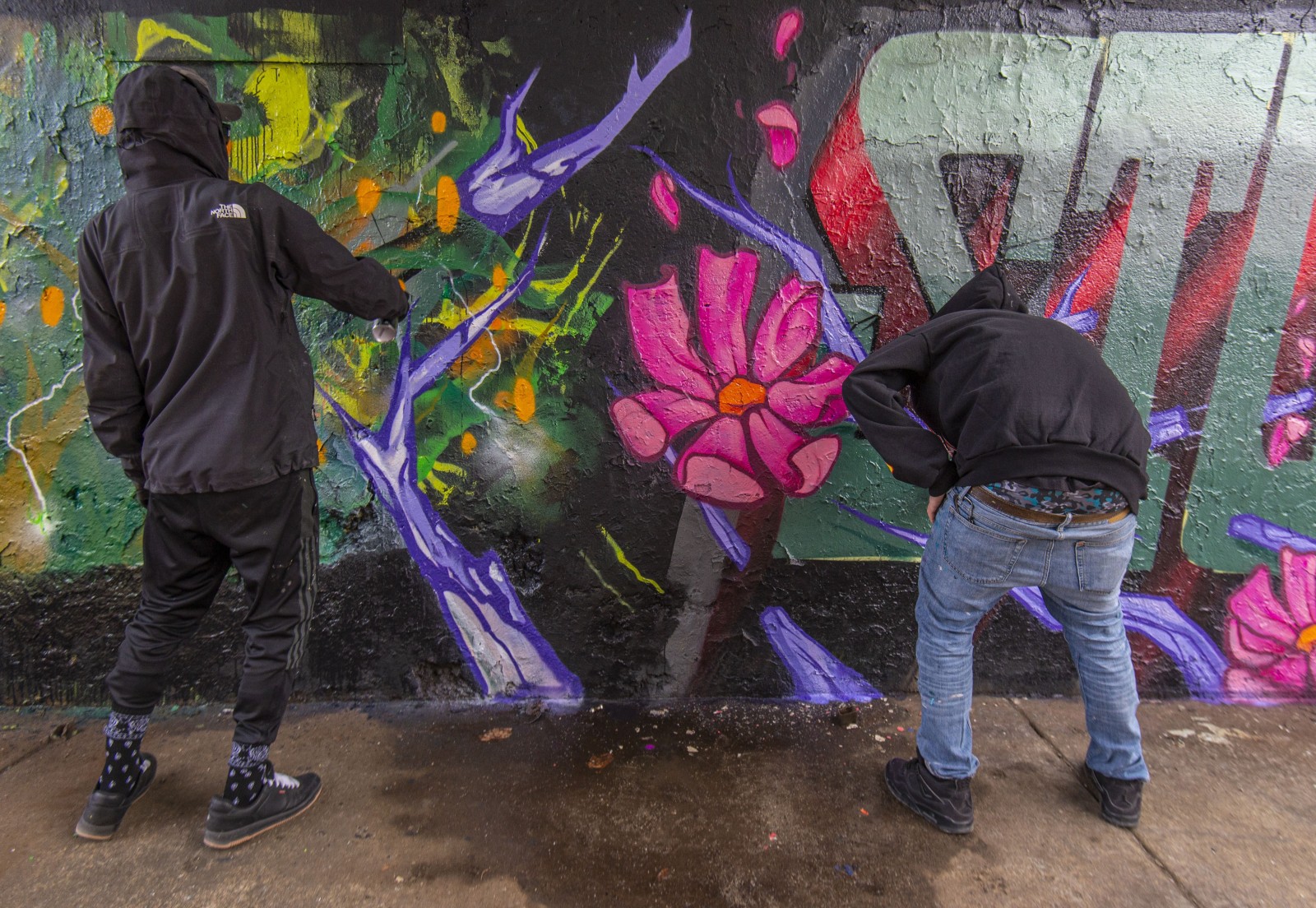 Street artists Joos and Stuck working together under the CTA Blue Line tracks, off Milwaukee Ave. and Wolcott St.