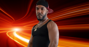 GMS RAW in a powerful stance against a backdrop of dynamic orange energy waves, representing his impactful presence in the rap and Philadelphia hip hop culture, as featured in his new hip hop track 2024 'Click Clout'.