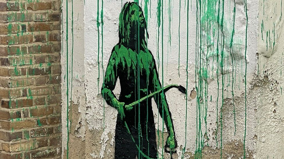 A stencilled painting of a figure holding a pressure sprayer