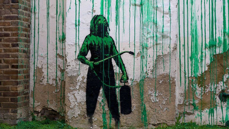 photograph shows a close up of a section of the banksy mural