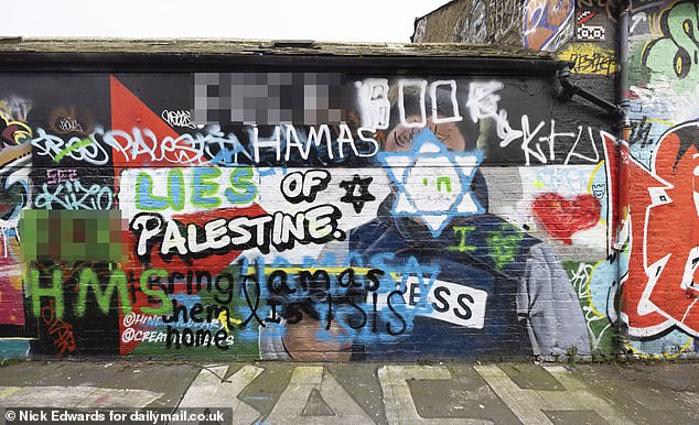A defaced mural featuring a portrait of Gaza journalist, Hind Osama Al-Khoudary, 29 depicted wearing a flak jacket marked with 'Press' in Allen Gardens, East London by artist Lucy Danielle