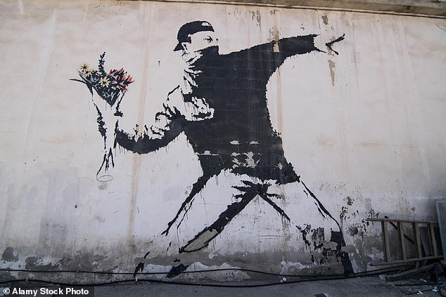 Banksy's famous mural, Rage, The Flower Thrower (Love Is In The Air), is painted on a car wash in a suburb of Bethlehem
