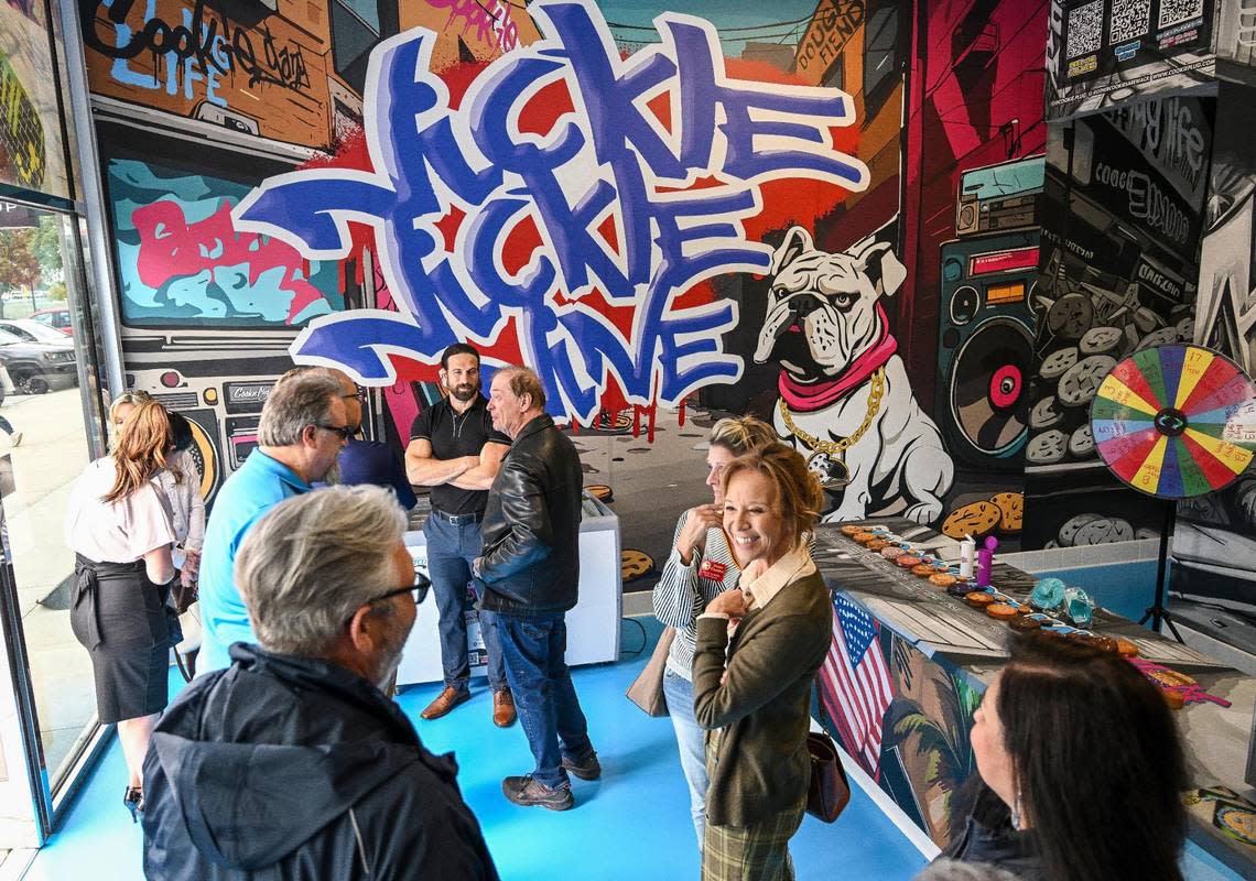 Cookie fans check out Cookie Plug’s new location featuring walls with graffiti and street art during its soft opening and ribbon-cutting event in Fresno State’s Campus Pointe shopping center. Its grand opening is this weekend.