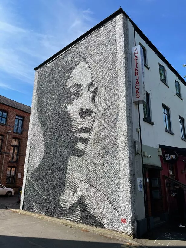 A street mural of a woman in Leicester
