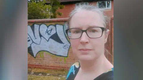 Rachel Hobbs-Harding  Rachel Hobbs-Harding selfie in front of the graffiti