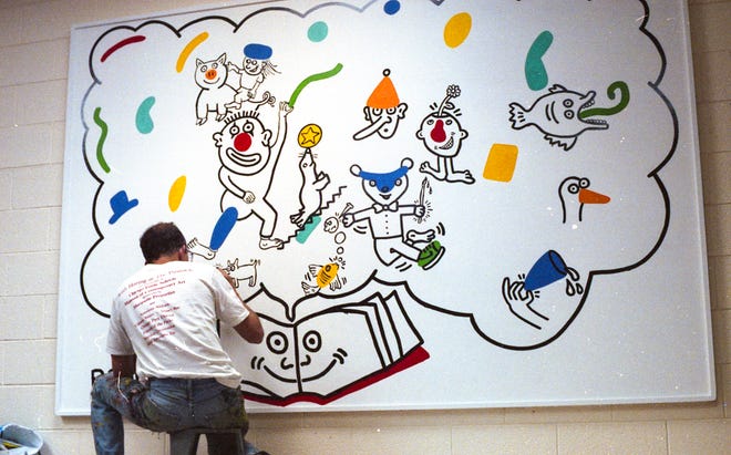 Keith Haring at work on the mural at Ernest Horn Elementary School in 1989.
