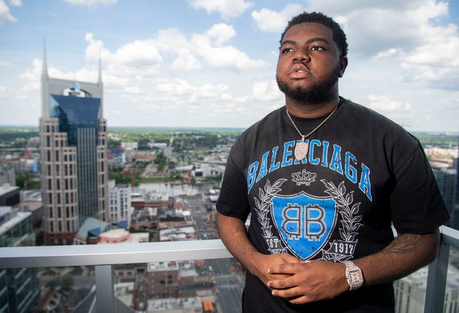 DJ KJ stands outside on the balcony at the studio space he works at in Nashville, Tenn., Monday, May 20, 2024.