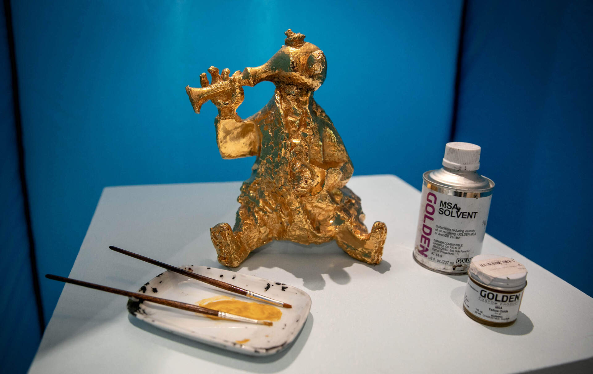 On display at Cambridge Arts' "Rust Happen(s) exhibit, a duplicate of Konstantin Simun's "Fokin Memorial" in Brattle Square with tools required to apply gold leaf. (Robin Lubbock/WBUR)