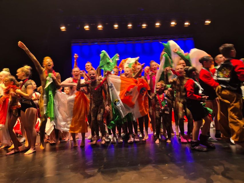 The dancers celebrate on stage after coming in third at the Dance World Cup