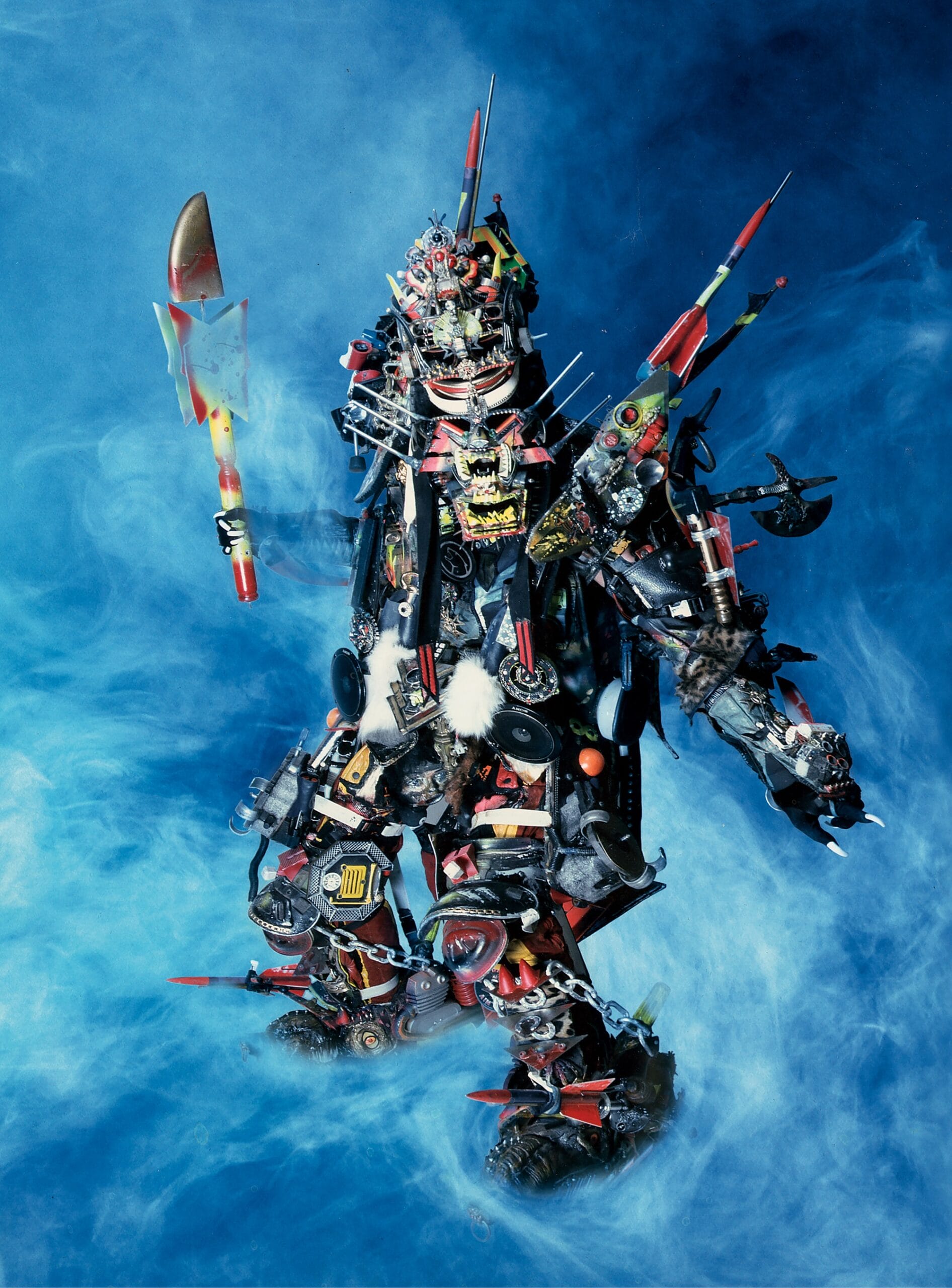 the artist Rammellzee in a futuristic costume, photographed on a swirling blue backdrop