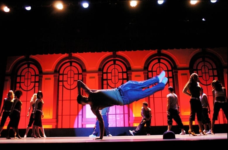 A scene from the film Step Up showing someone on stage breakdancing.