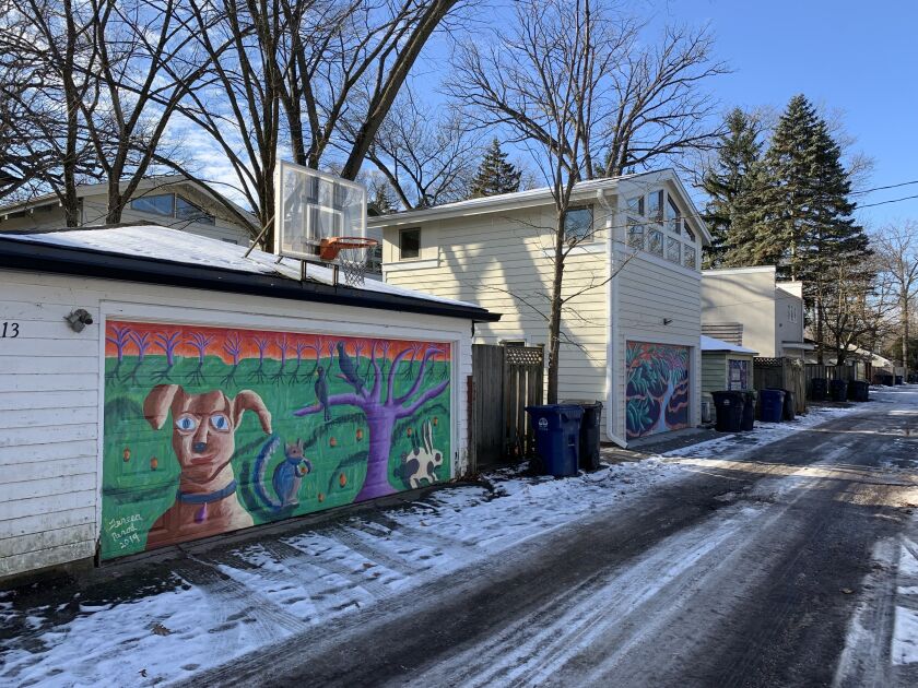 Teresa Parod painted a series of garage murals in Evanston in 2019, including this one, left, featuring someone’s pet dog.