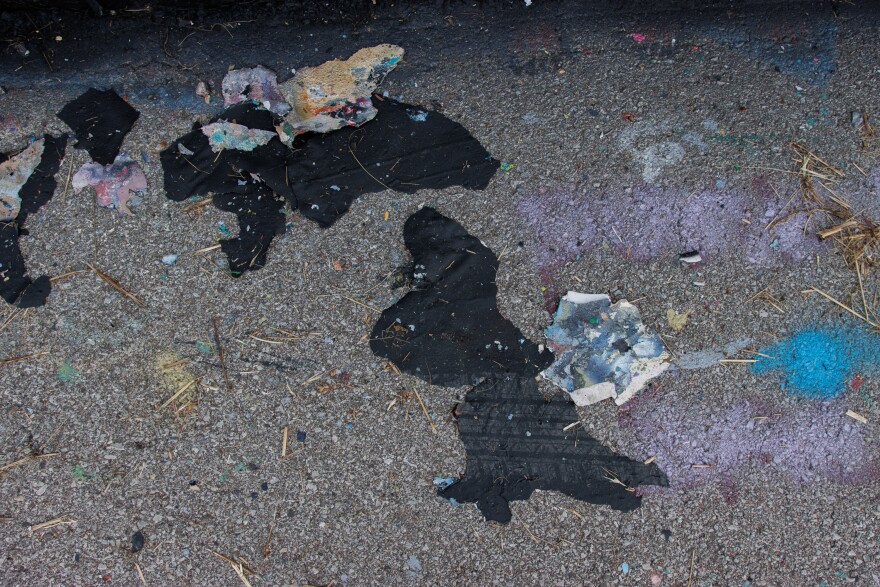 Left over paint from on the wall lays on the pavement along the Mississippi River on Friday, August 30, 2024.