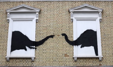 Two elephants painted on to the side of house.