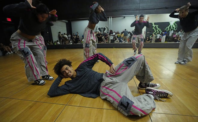 August 1, 2024; Mesa, Ariz., U.S.; Isaiah Wilson (center) lands a flip with the Legendz dance team during a performance for friends and family as the team practices for the Hip Hop International's World Hip Hop Dance Championship Aug. 1, 2024, in Mesa, Arizona.