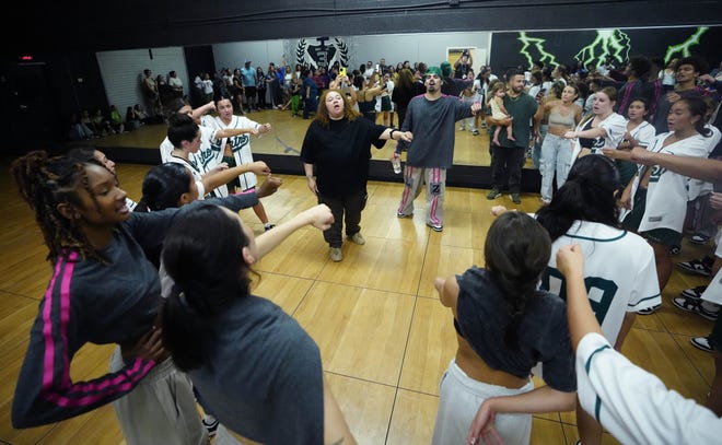 Stefani Patrick and Benjamin Valverde bring in the teams for a cheer before departing during a performance for friends and family as the team practices for the Hip Hop International's World Hip Hop Dance Championship Aug. 1, 2024 in Mesa, Arizona.