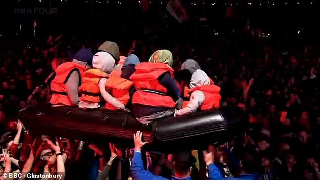 A blow-up small boat surfed the crowd during the performance by Idles at Glastonbury