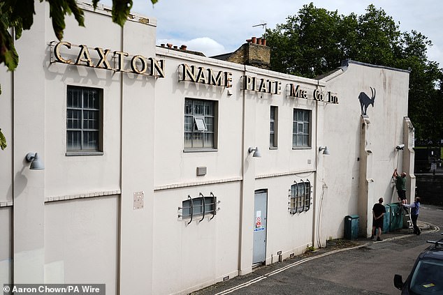 The artist's new piece in London features the goat silhouette with rocks falling down below it