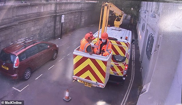 One of the men in Kew Bridge, who is masked (right), is believed to be elusive artist Banksy