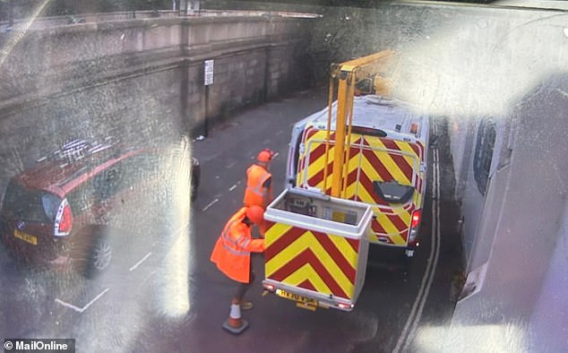 Footage captured by CCTV showed a cherry picker van with two men dressed in orange high-vis clothing and helmets - one of whom is believed to be Banksy - in Kew Bridge yesterday