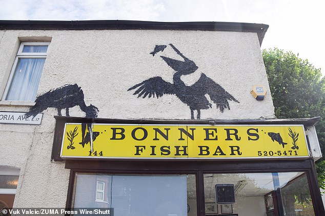 The mural sits above Bonners Fish Bar, on Northcote Road. It is based on a quiet residential street in east London