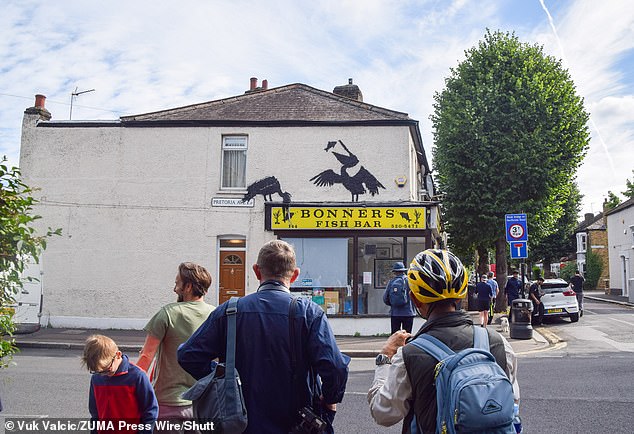 Excited fans and locals gazing at the latest Banksy piece which forms part of his animal-based collection which were unveiled this week