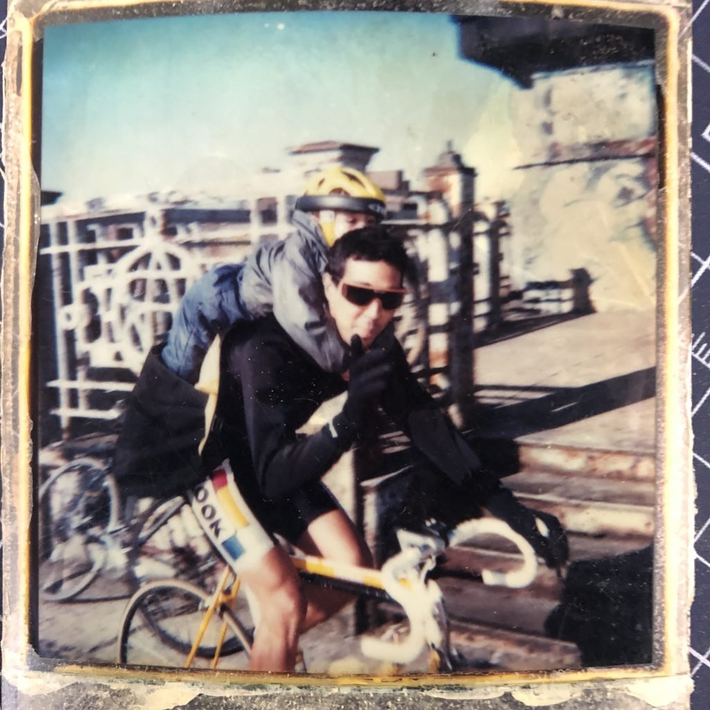 Photo of Futura 2000 and his son on a bike, 1980s.