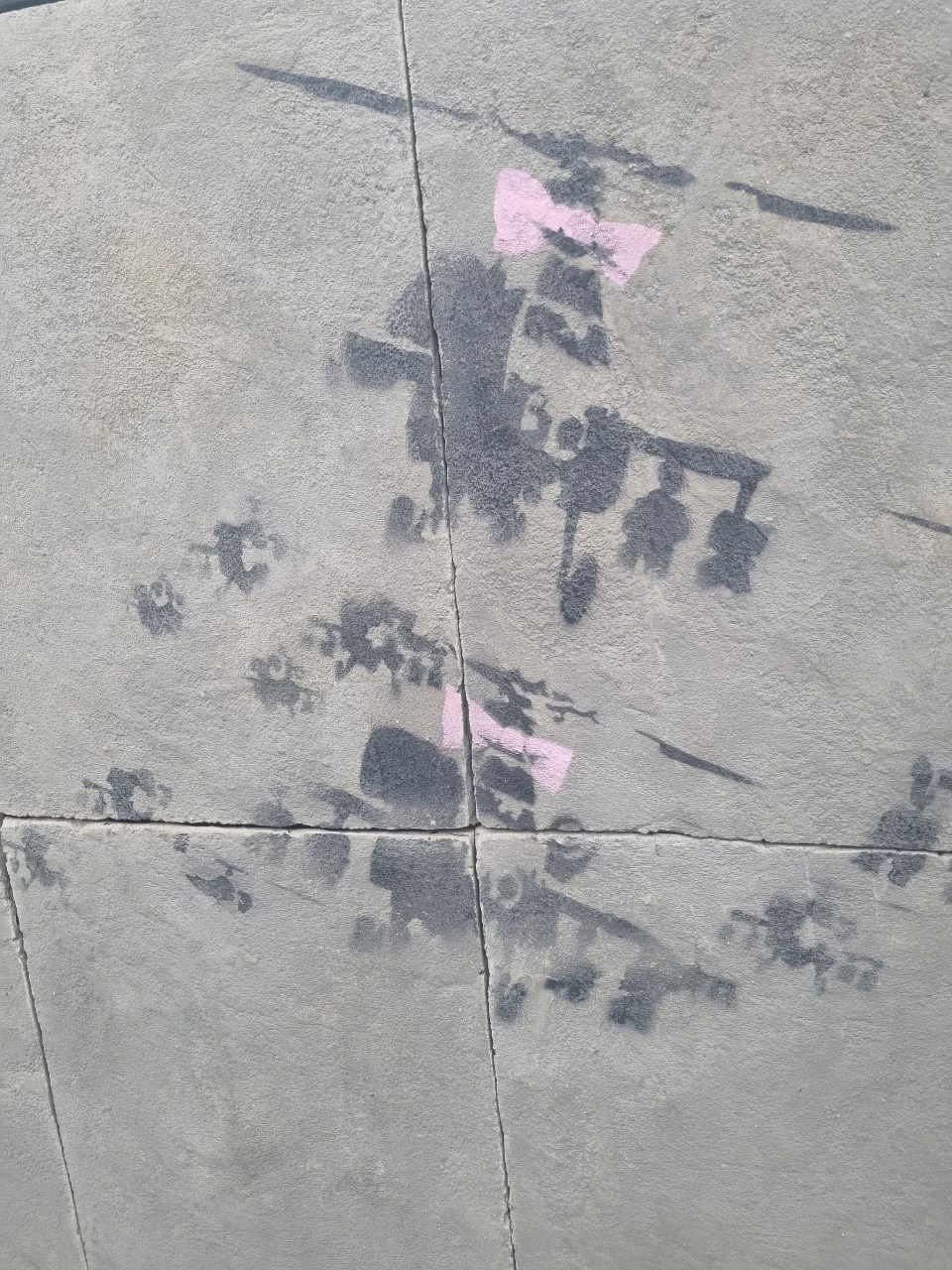 The street artist spray-painted Appache attack helicopters with pink bows on them