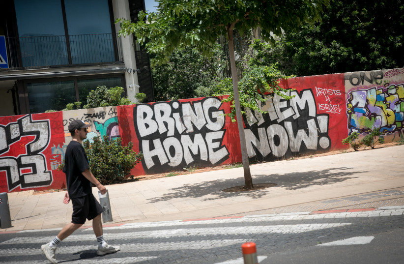 ''Bring them home Now'' grafitti in Park haMesila in South Tel Aviv, May 21, 2024 (credit: MIRIAM ALSTER/FLASH90)