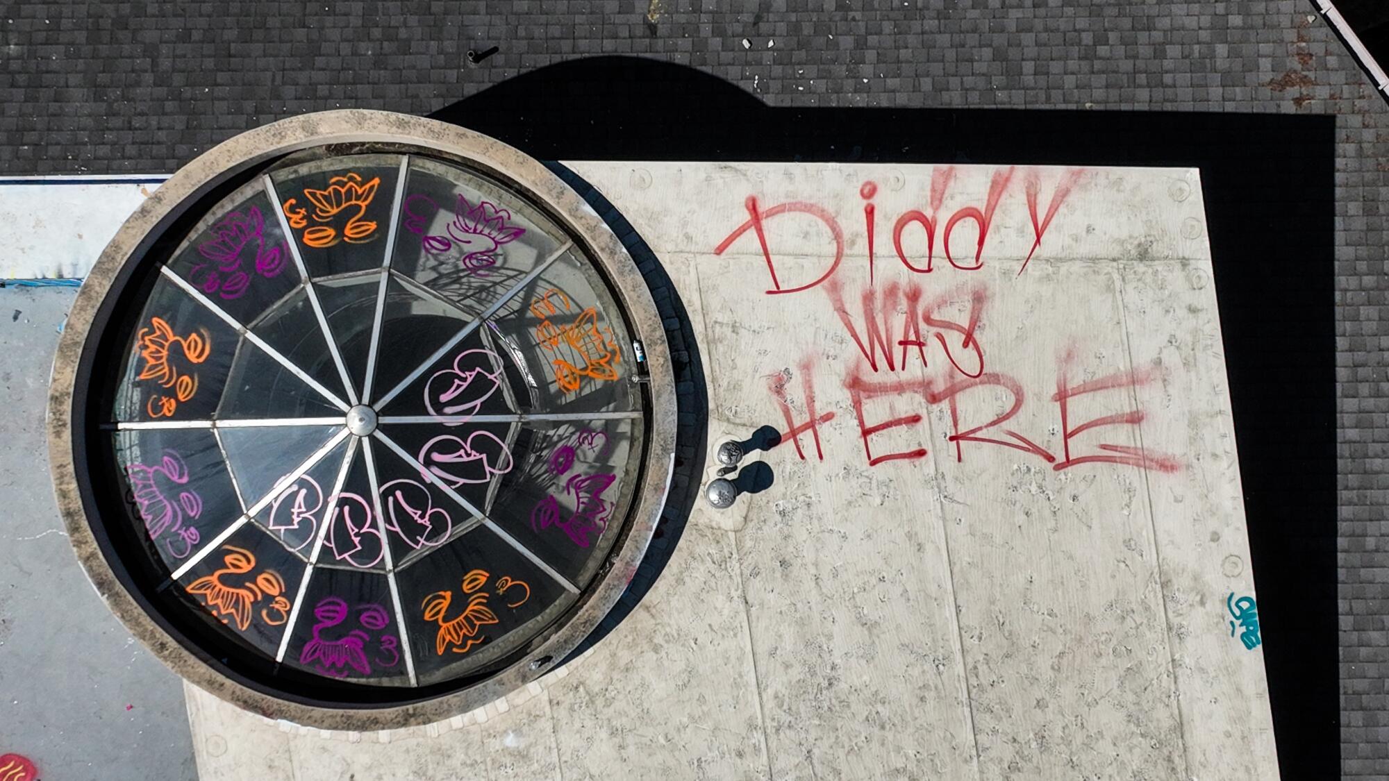 A rooftop view of an abandoned Hollywood Hills mansion defaced by taggers.