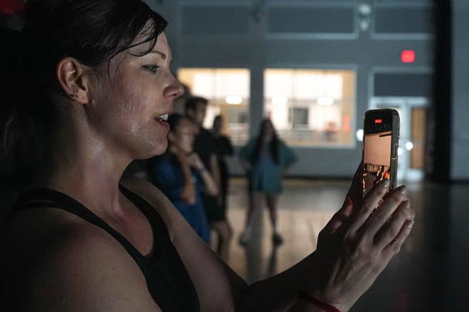 Casey O'Neal takes video for a classmate during the Hip Hop Groovers of Austin dance class at Ballet Austin’s Butler Center of Dance and Fitness on Monday, Sept. 9, 2024.