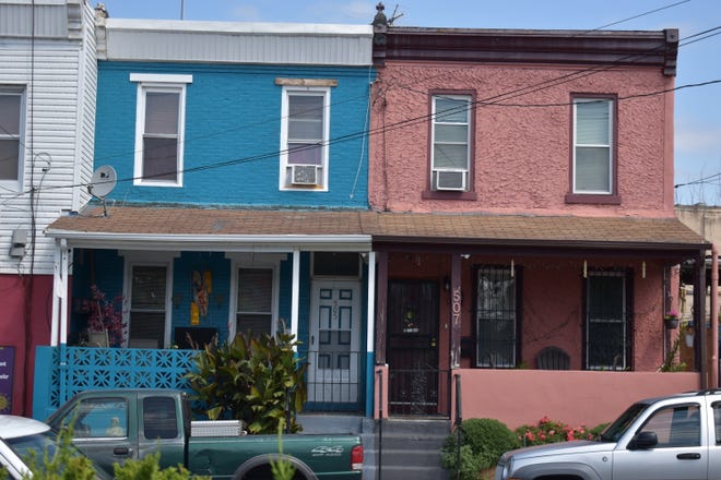 Two colorful houses vie for attention on the 500 block of Erie Street in North Camden.