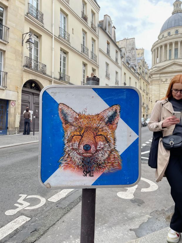 A charming fox as created by SMiLE brightens an ordinary street sign in Paris. SMiLE's art will be celebrated at a new exhibit at the NoBo Art District's Bus Stop Gallery. (SMiLE/Courtesy photo)