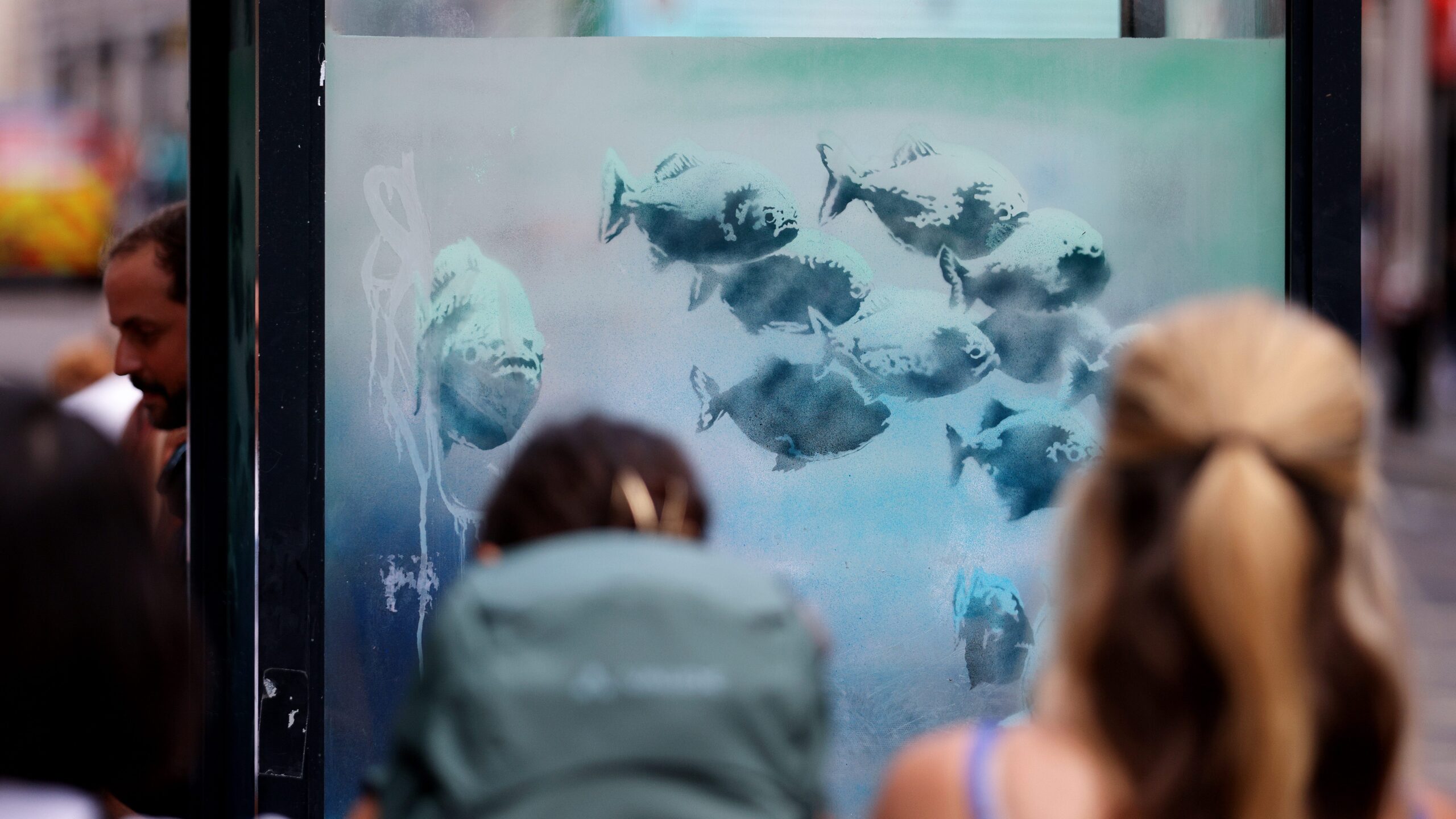 A Banksy painting shows piranhas in a London police box.