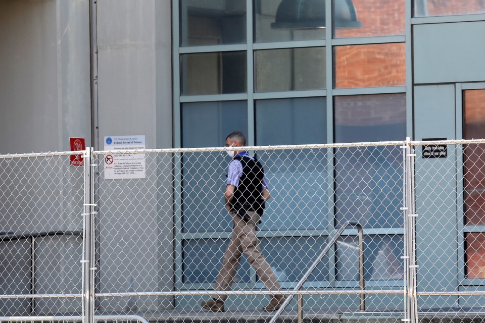 A law enforcement officer walks outside the entrance to the MDC