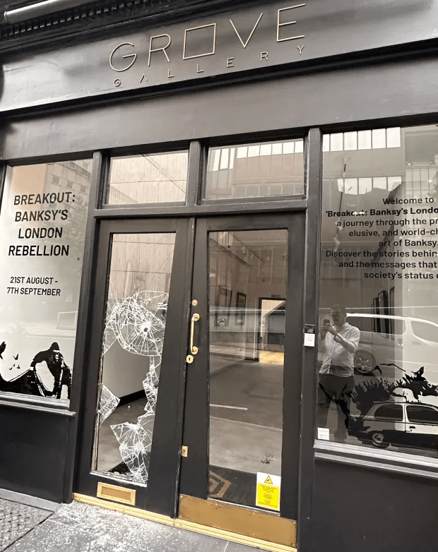 The glass door of Grove Gallery can be seen smashed