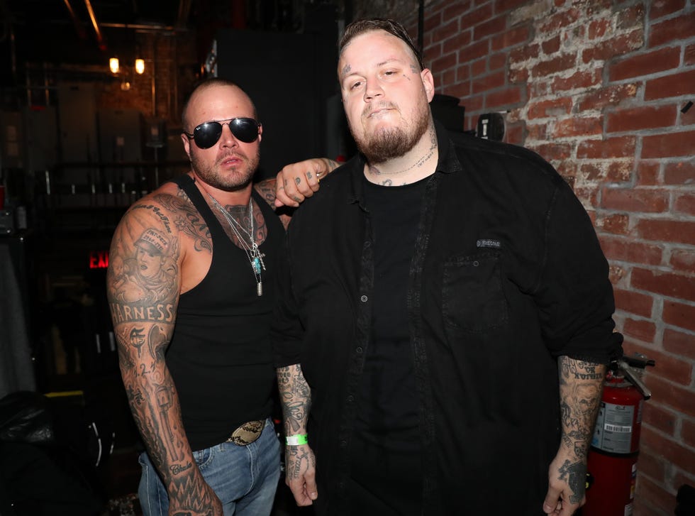 struggle jennings and jelly roll posing in a backstage area at a concert