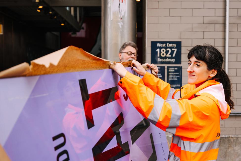 Sound Transit staff members from the STart team help with an art installation