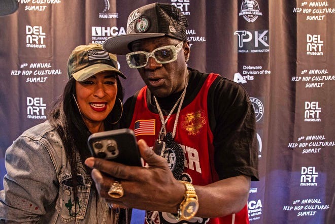 From left, CEO of One Village Alliance, Chandra Potts and Headliner Flavor Flav are featured at the second Hip Hop Cultural Summit at the Delaware Art Museum in Wilmington, Saturday, Oct. 26 2024.