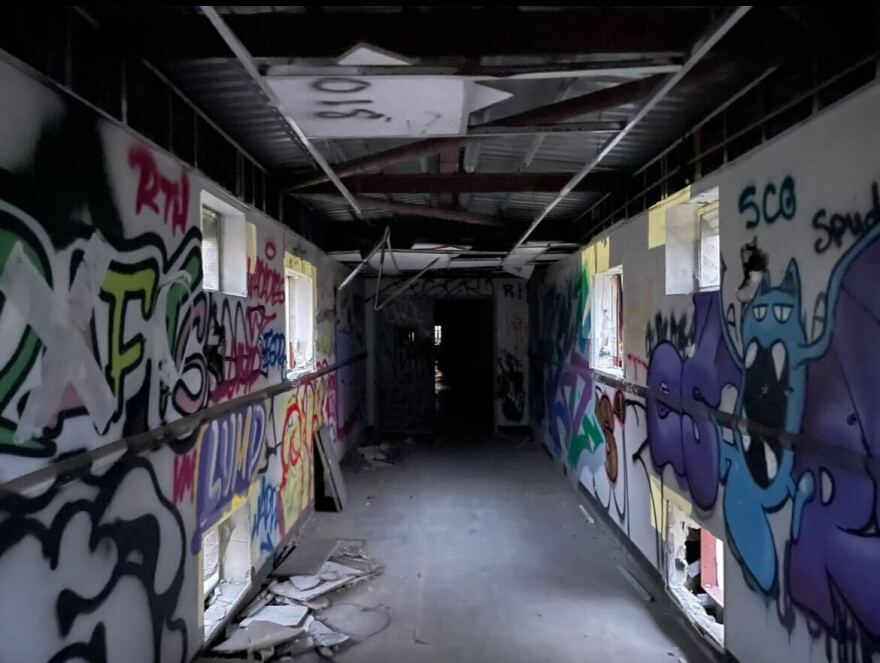 A graffiti-covered hallway inside an abandoned Naval base in New Orleans.