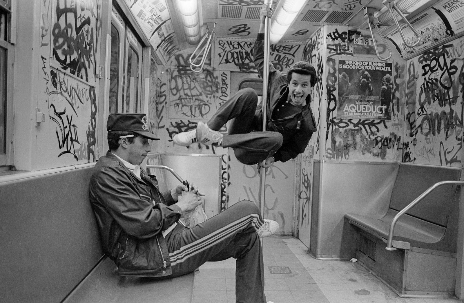 Two young men on the graffitifilled subway.